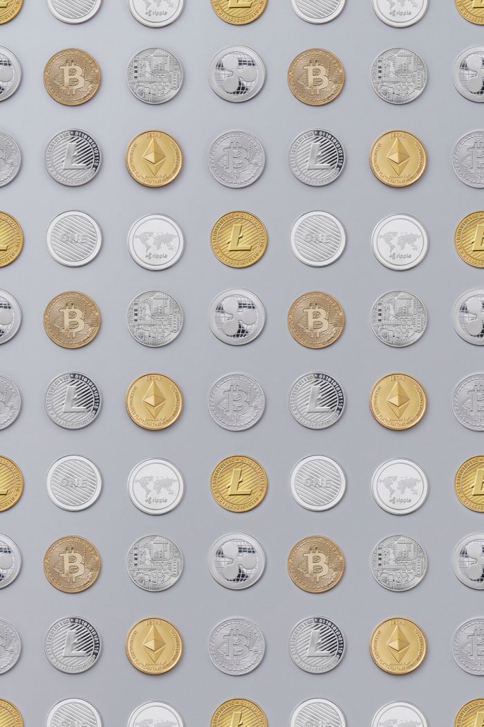 Flat lay of various cryptocurrency coins on white background, showcasing digital currency concept.